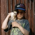 Picture Title - portrait of boy with pet hen