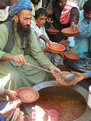 Picture Title - Pathan pours charity soup in Sehwan Sharif