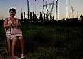 Picture Title - A woman waiting in the sunset in front of an electric power station