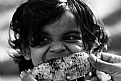 Picture Title - A Kid tasting a fresh Corn