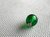 One tiny green button